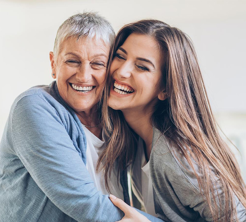 Happy adult mother and daughter embracing