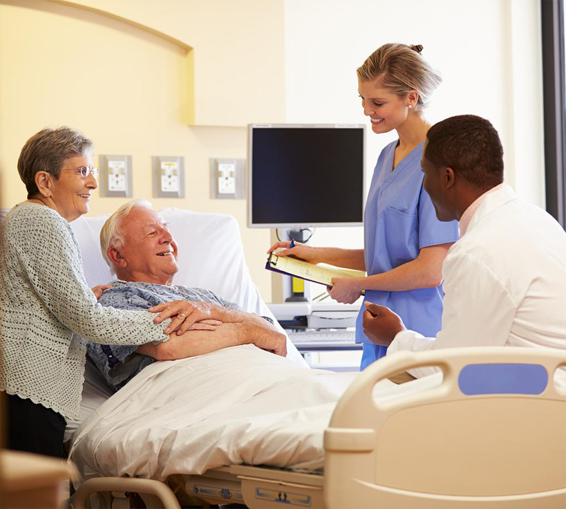 Doctor and nurse meeting with senior couple at a hospital